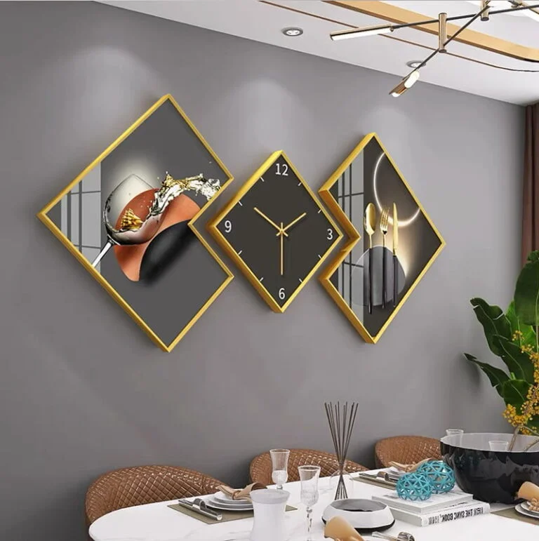 Modern luxury wall art and clock set with gold frames in a dining room.