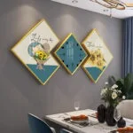 Modern wall art and clock set with floral designs in a dining room.