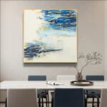 Modern abstract wall art with blue and gold accents in a dining room setting.