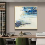 Modern abstract wall art with blue and gold tones in a luxury dining room setting.
