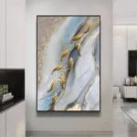 Modern abstract wall art with gold accents in a luxury home setting.