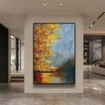 Modern framed wall art with abstract autumn landscape in luxury home setting.