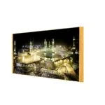 Illuminated Kaaba wall art with gold frame, featuring Islamic decor and modern luxury design.