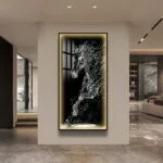Modern illuminated wall art with abstract horse design in luxury home setting.