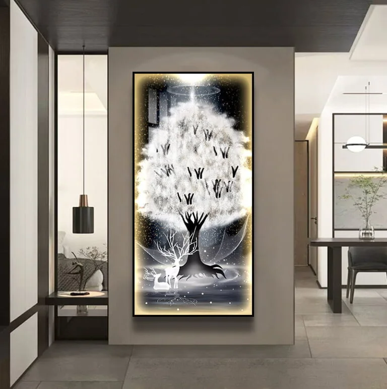 Illuminated modern wall art with tree design in a luxury home setting.