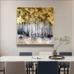 Modern framed wall art with abstract forest design in a dining room setting.