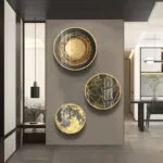 Modern luxury wall art with gold and black circular designs in a contemporary living space.
