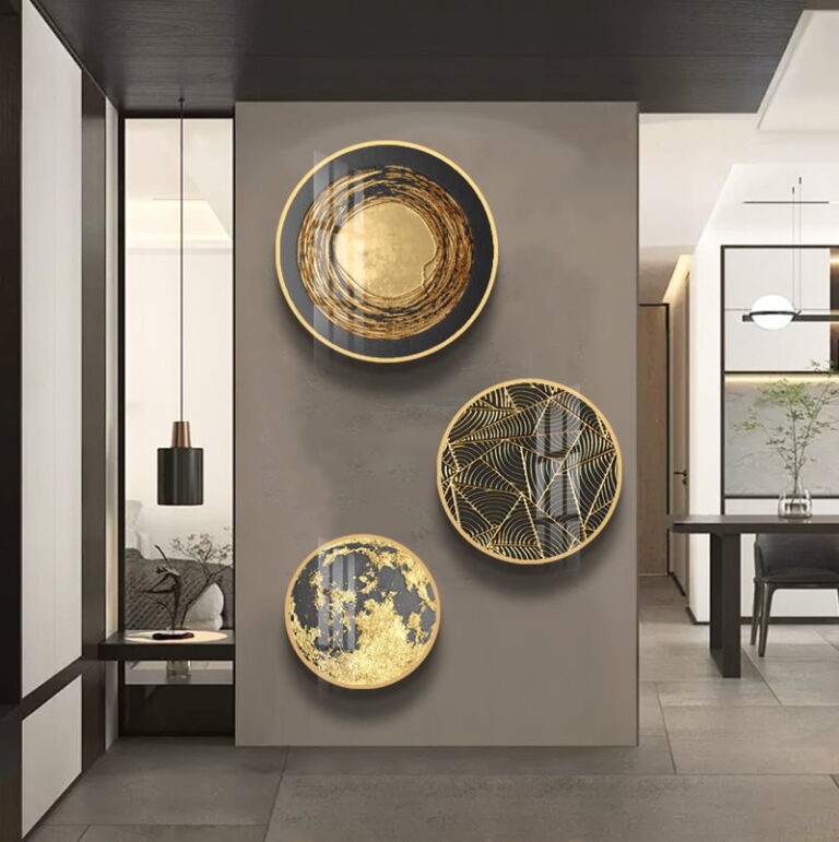 Modern luxury wall art with gold and black circular designs in a contemporary living space.