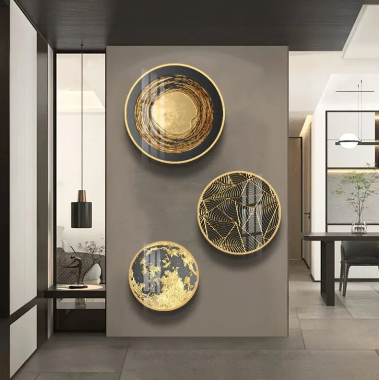 Modern luxury wall art with gold and black circular designs in a contemporary living space.