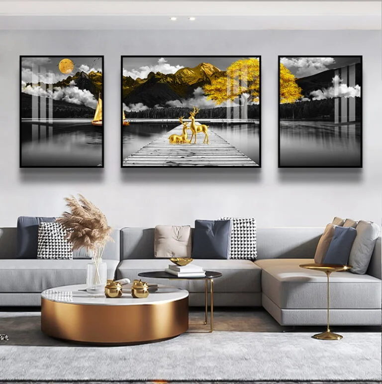 Modern living room with framed wall art featuring a serene lake and mountains, complemented by luxury decor.