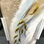 Modern abstract wall art with gold accents and textured design.