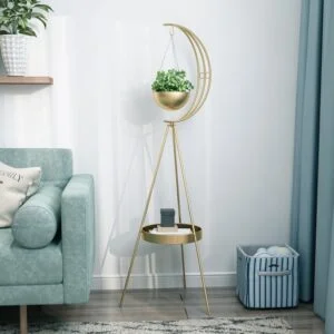 Modern gold indoor planter with crescent design and small table in a stylish living room.