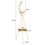 Gold decorative planter with crescent moon design and tripod stand.