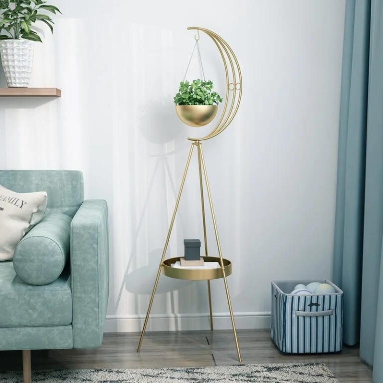 Modern gold indoor planter with crescent design and small table in a stylish living room.