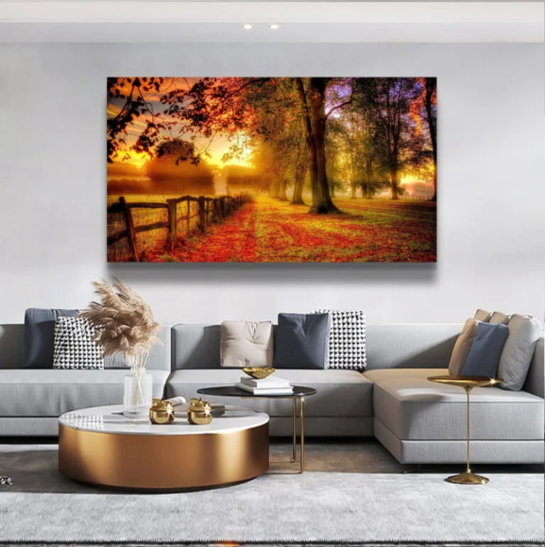 Modern living room with large framed wall art of a vibrant autumn landscape.