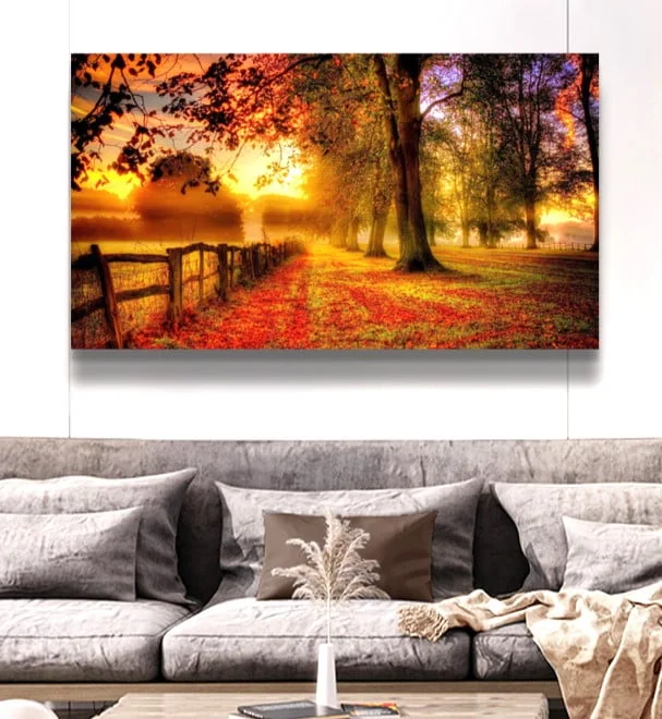 Modern wall art with autumn landscape above a stylish sofa in a luxury living room.