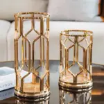 Elegant gold decorative vases on a modern coffee table in a luxury living room setting.
