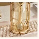 Elegant gold decorative vase on textured table runner, modern home decor.