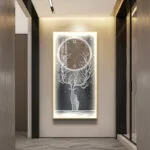 Illuminated wall art with tree and clock design in modern hallway.