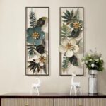 Modern floral wall art with metal frames above a console table with decorative deer figurines.