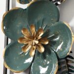 Modern metal wall art featuring a teal and gold flower design.