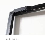 Close-up of a black metal frame hook for wall art installation.