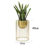 Gold metal planter with green plant, modern home decor accessory.