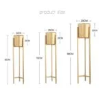 Set of three gold metal planters with stands in varying heights.
