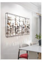 Modern aluminium framed wall art with leaf design in a bright room.