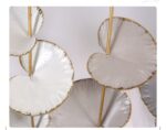 Modern decorative wall art with gold accents and abstract design.