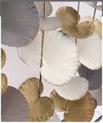 Modern metal wall art with gold and silver circular accents.