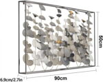 Modern aluminum framed wall art with abstract leaf design in neutral tones.