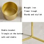 Gold wrought iron flower trough with stable triangle bracket.