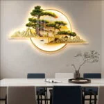 Illuminated wall art with tree and mountain design in a modern dining room.
