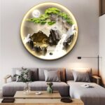 Illuminated round wall art with nature scene above modern sofa in living room.