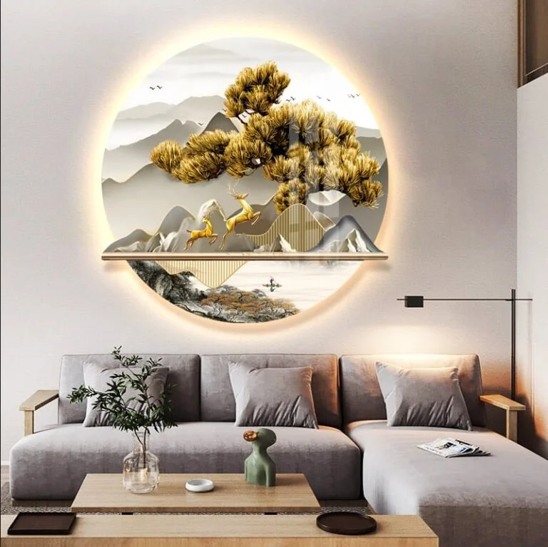 Modern illuminated wall art with nature scene above a stylish living room sofa.