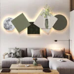 Modern illuminated wall art with geometric shapes and vase design in a luxury living room.