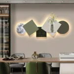 Modern illuminated wall art with geometric shapes and vase, enhancing luxury home decor.