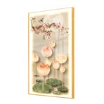 Illuminated wall art with lotus flowers and moon, framed in gold.