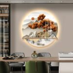 Illuminated modern wall art with mountain and tree design in a luxury home setting.
