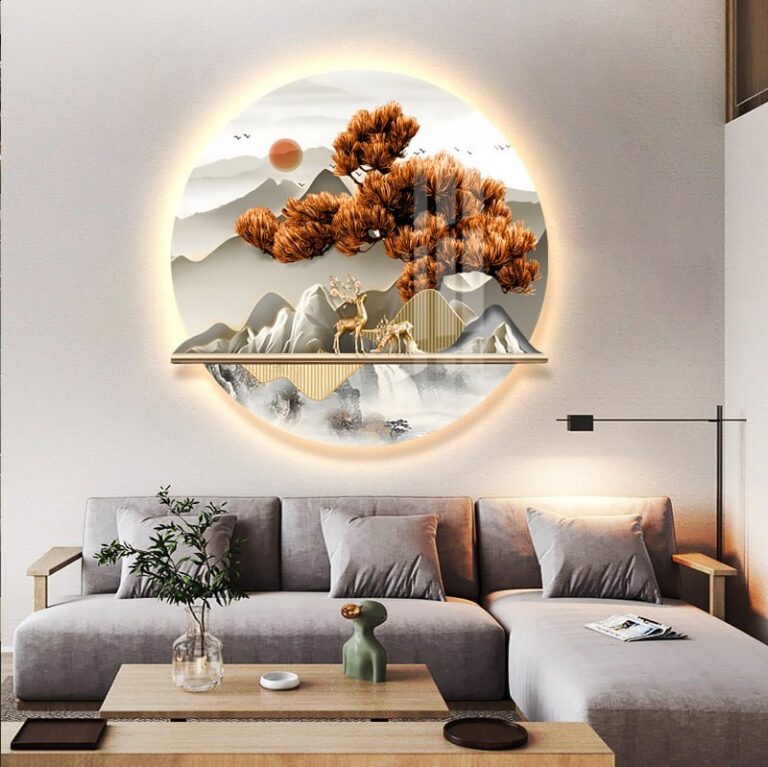 Modern illuminated wall art with nature scene above a stylish living room sofa.