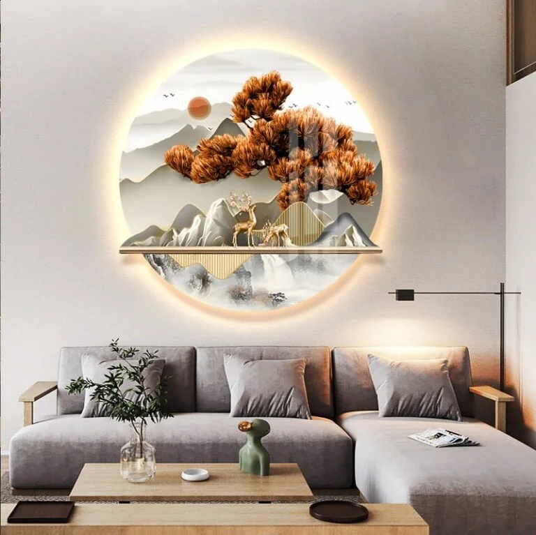 Modern illuminated wall art with nature scene above a stylish living room sofa.