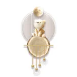 Modern decorative wall art featuring a bear figurine with gold accents and circular design elements.