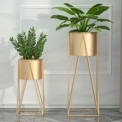 Modern gold metal planters with green plants for luxury home decor.