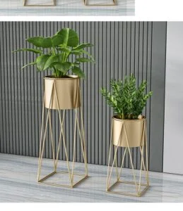Modern gold metal planters with green plants on a sleek floor, enhancing luxury home decor.