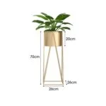 Gold metal indoor planter with green plant, modern home decor.