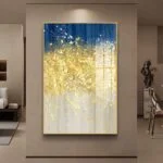 Modern luxury wall art with gold and blue abstract design in a living room setting.