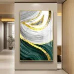 Modern abstract wall art with gold, green, and gray swirls in a hallway setting.