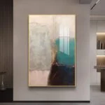 Modern abstract wall art with gold frame in a luxury home setting.