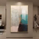 Modern abstract wall art with gold frame in a luxury living room setting.